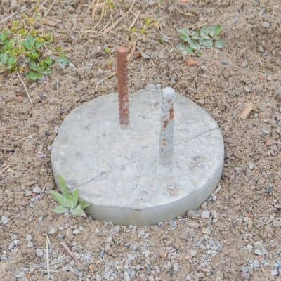 Property line markers showing a concrete survey monument and rebar used to identify boundary corners